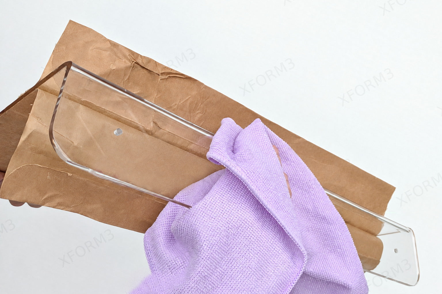 Soft cloth wiping the back of the clear acrylic mounting lip